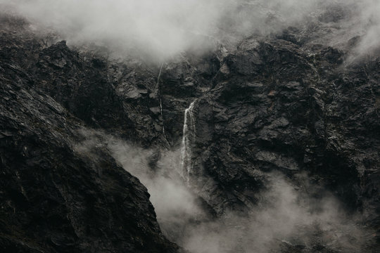 Zealand Waterfall Surrounded By Rock
