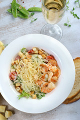 Caesar salad with shrimp on the table