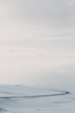 View of snowy winding road