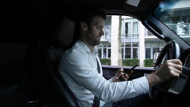 A middle aged caucasian man distracted driving while using a mobile device stops his vehicle suddenly to avoid an accident. - HD 24FPS