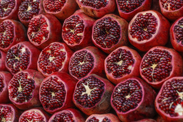 Raws of juicy red pomergranates