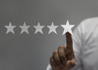 Five stars (5) rating with a businessman touching screen, concept about positive customer feedback...