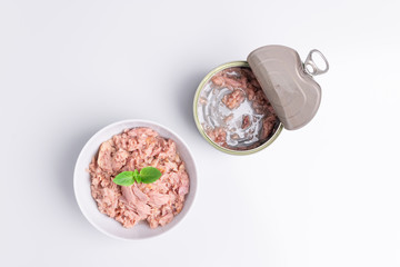 Canned tuna in a white bowl, isolated on white; empty open tuna tin on a white background; copy...