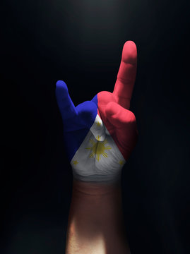 Rock and roll hand painted in Philippine Flag in black isolated background. 