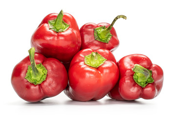 Group of five whole sweet red bell pepper isolated on white background