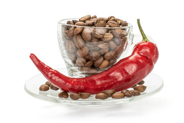 One whole fresh hot pepper with full cup of coffee beans isolated on white background
