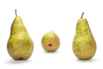 Group of three whole fresh green pear conference two in focus isolated on white background