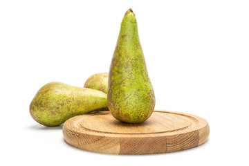 Group of three whole fresh green pear conference on bamboo plate isolated on white background