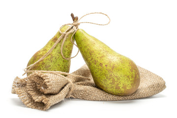 Group of two whole fresh green pear conference with jute bag isolated on white background