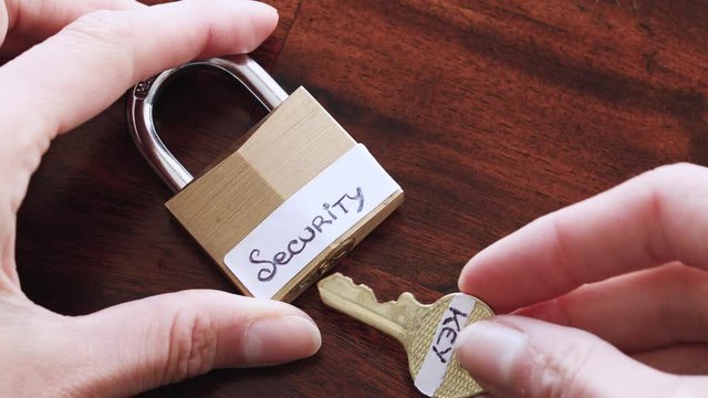 data protection online, hand using key to open up a lock with Security label on it