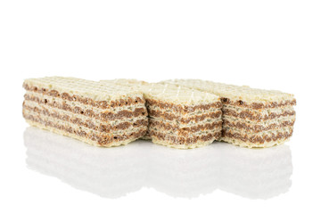 Group of three whole crispy beige hazelnut wafer cookie isolated on white background