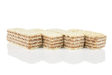 Group of four whole crispy beige hazelnut wafer cookie isolated on white background