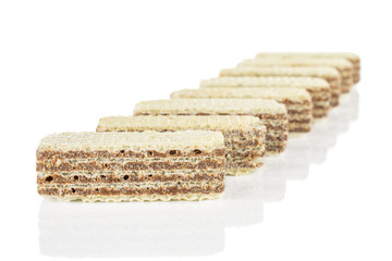 Lot of whole crispy beige hazelnut wafer cookie isolated on white background