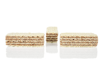 Group of three whole crispy beige hazelnut wafer cookie isolated on white background