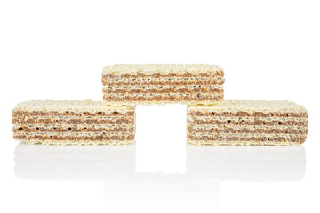 Group of three whole crispy beige hazelnut wafer cookie isolated on white background