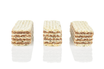 Group of three whole crispy beige hazelnut wafer cookie in row isolated on white background