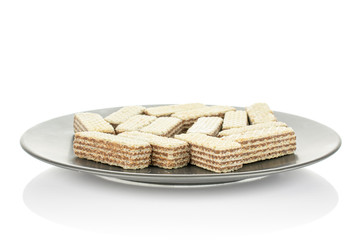 Lot of whole crispy beige hazelnut wafer cookie on gray ceramic plate isolated on white background