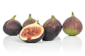 Group of four whole two halves of sweet purple fig isolated on white background