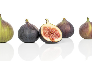 Group of four whole one half of sweet purple fig isolated on white background