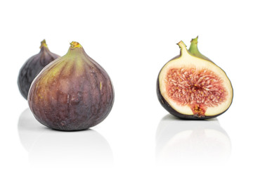 Group of three whole one half of sweet purple fig isolated on white background