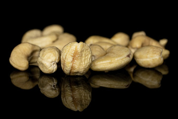 Fototapeta na wymiar Lot of whole brown nut cashew heap isolated on black glass
