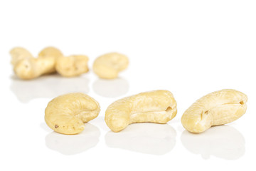 Fototapeta premium Lot of whole brown nut cashew three in focus isolated on white background