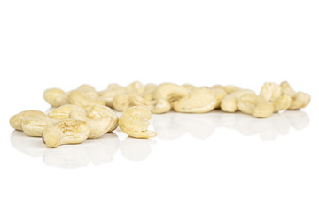 Lot of whole brown nut cashew heap isolated on white background