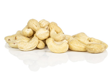 Lot of whole light brown nut cashew heap isolated on white background