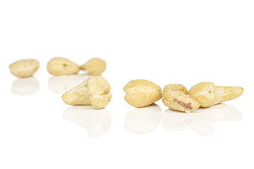Lot of whole brown nut cashew front focus isolated on white background