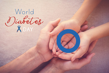 adult and child holding blue circle, copy space background, World Diabetes day