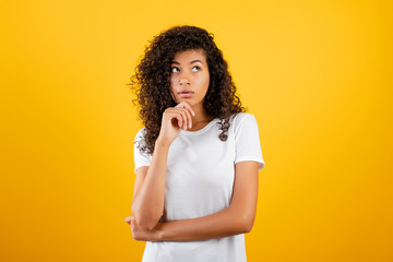 young black woman thinking isolated over yellow