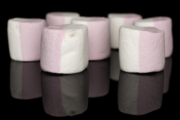 Group of seven whole sweet pastel marshmallow isolated on black glass