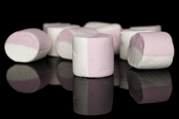 Lot of whole sweet pastel marshmallow isolated on black glass