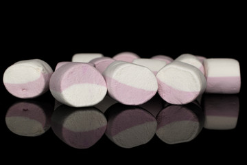 Lot of whole sweet pastel marshmallow isolated on black glass