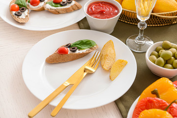 Plate with food on table set for big family dinner