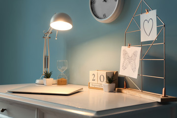 Modern stylish workplace with glowing lamp
