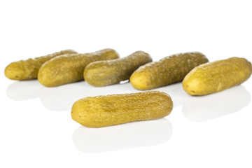Group of six whole sour green pickle isolated on white background