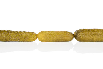 Group of three whole sour green pickle isolated on white background