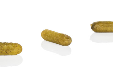 Group of three whole sour green pickle isolated on white background