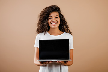 young beautiful black woman with laptop in hands isolated over brown