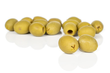 Lot of whole marinated green olive isolated on white background