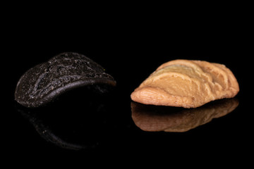 Group of two whole colorful pasta orecchiette isolated on black glass
