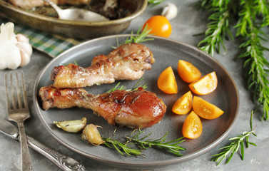 Baked chicken drumsticks with rosemary on a concrete background. top view. copy space. keto recipe, low carb
