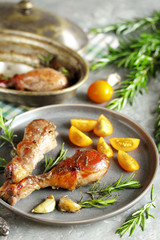 Baked chicken drumsticks with rosemary on a concrete background. top view. copy space. keto recipe, low carb