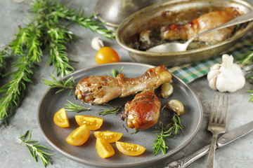 Baked chicken drumsticks with rosemary on a concrete background. top view. copy space. keto recipe, low carb