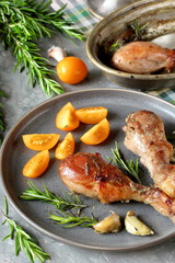 Baked chicken drumsticks with rosemary on a concrete background. top view. copy space. keto recipe, low carb