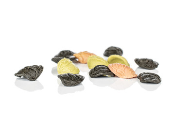 Lot of whole colorful pasta orecchiette isolated on white background