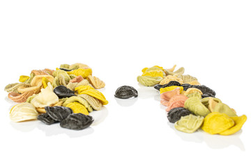 Lot of whole arranged colorful pasta orecchiette isolated on white background