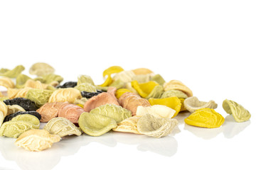 Lot of whole colorful pasta orecchiette heap isolated on white background