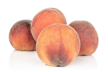 Group of four whole sweet red peach isolated on white background